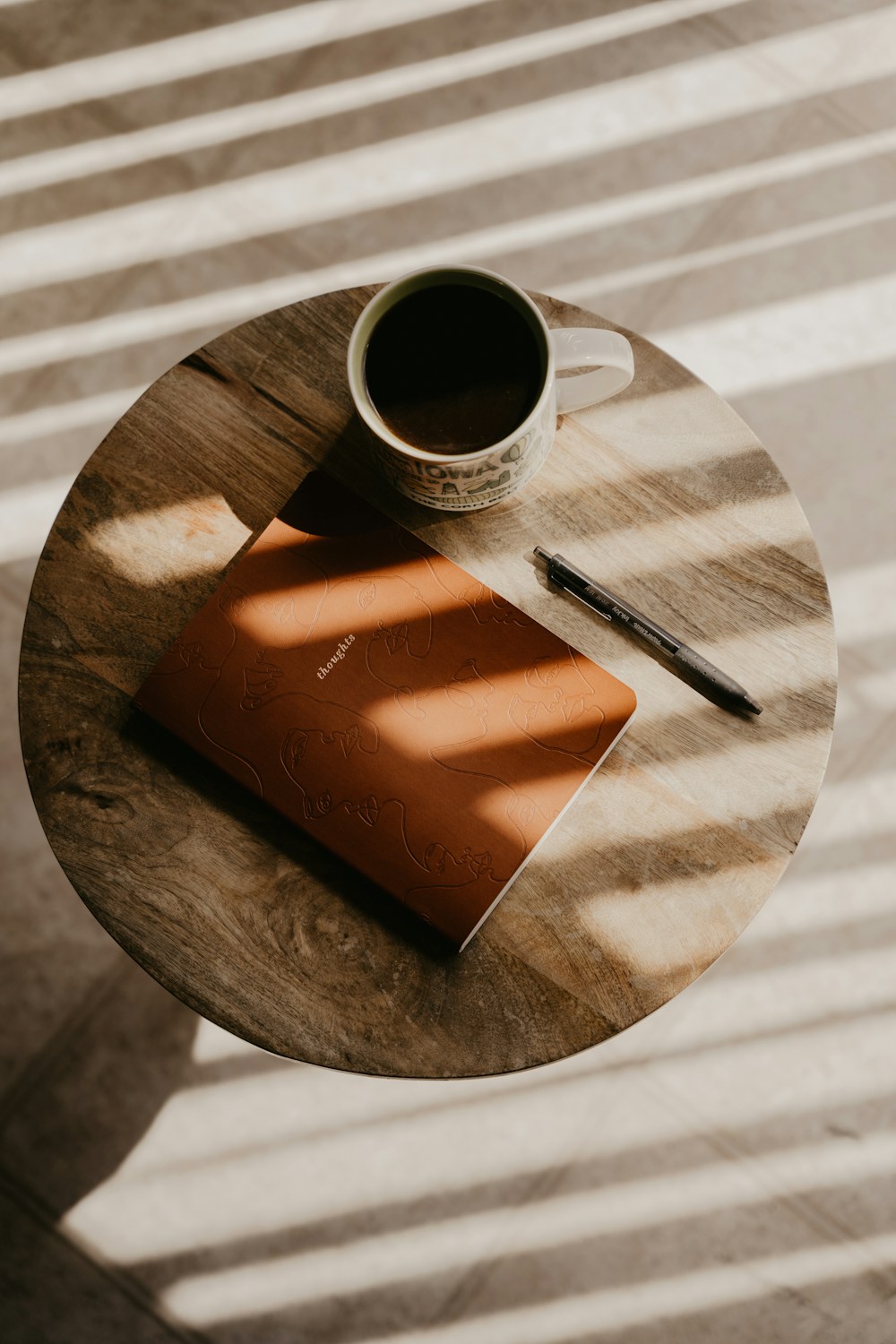 Coffee and a journal in warm natural light
